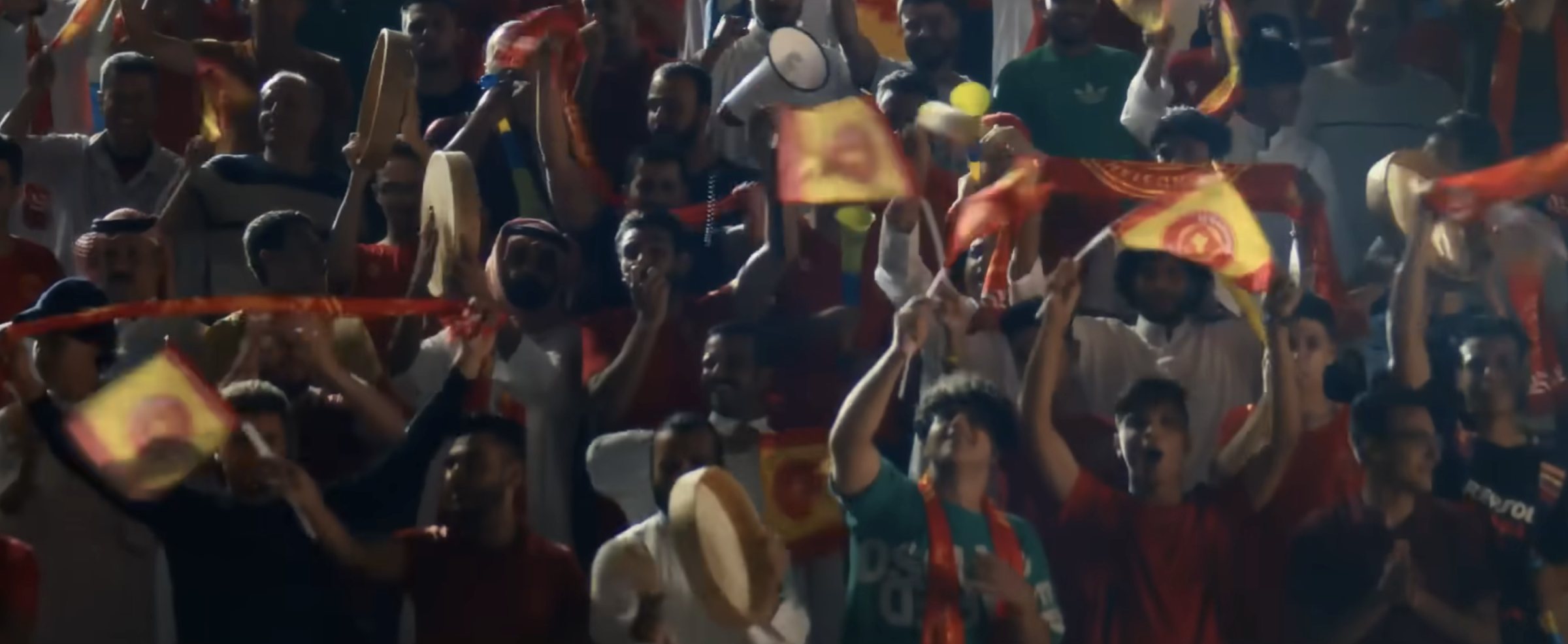 Fans cheering with flags and drums